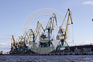 The river Port cranes load coal into railway.