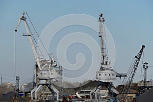 River port. The factory by the river. Sand mining. A crane and special equipment for loading sand.