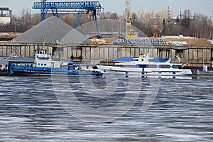 River port. The factory by the river. Sand mining. A crane and special equipment for loading sand.