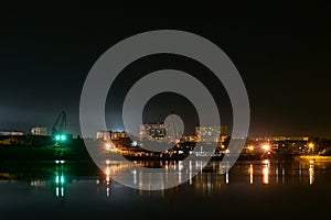 River port in the industrial area of the city at night. Urban landscape