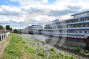 River port Kostroma city retro cruise liners. The Volga River. Avenues of deciduous trees on the embankment. Blue sky photo