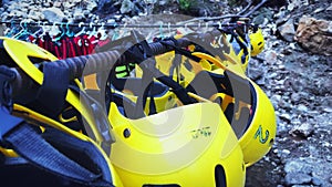 River rafting equipment hanging outdoors near lake bank. Protective helmets for rafting tours, close up. Active sport concept. Rec