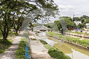 River with railway bridge, construction sites and The Exchange 106