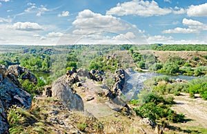 River with rapids and a rock outcrops on its banks