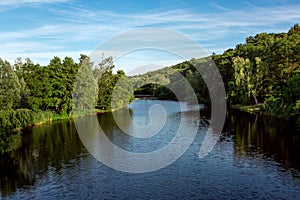 The river recedes into the distance on the shore. photo