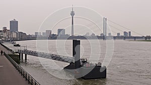 River Rhine at Dusseldorf Germany, Oberkasseler bridge with a view of the skyline, a day with cloudy weather