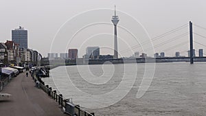 River Rhine at Dusseldorf Germany,view to the shore promenade, in the background Oberkasseler bridge and Tower