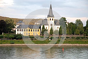 River Rhine and small town with white church near Bonn in Germany