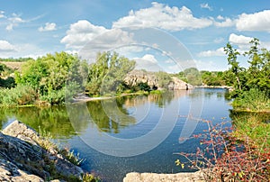 River with rock outcrops and trees on its banks