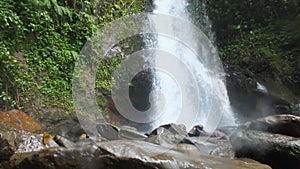 River rock with waterfall background