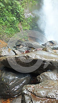 River rock with waterfall background