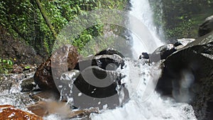 River rock with waterfall background