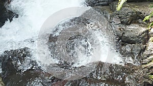 River rock with waterfall background