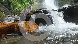 River rock with waterfall background