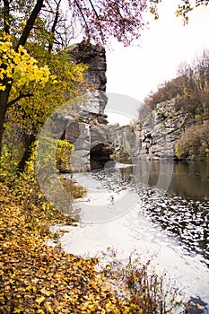 River and rocks. Beautiful canyon. Yellow leaves on the shore. Autumn landscape