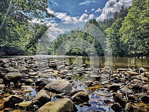 The River, rocks, blue sky and clouds