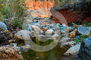river between rocks inse the forest photo