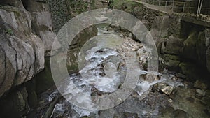 River between rocks of a narrow gorge. Stream of water is squeezed between the sides of the rocks. Taubenlochschlucht, Taubenloch