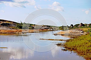 River, rocks  and undergrowth with some vegetation in the region close to the sea, northeast of Brazil. photo