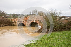 River Rother flood waters flow under bridge at Bodium, Kent