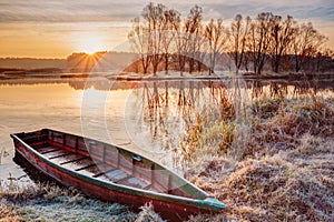 River and rowing fishing boat at beautiful sunrise