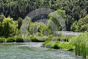 A river running through green landscape.