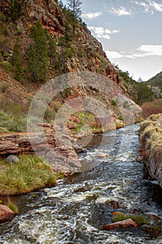 River runs at the base of cliff in Jemez Springs, New Mexico