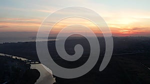 River and sea in the evening. Silhouettes of buildings in the city of Mariupol