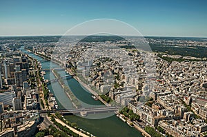 River Seine, greenery and buildings in a sunny day, seen from the Eiffel Tower top in Paris.