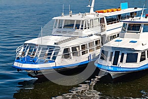 River ships at the pier. Two river pleasure craft moored in the port awaiting boarding of passengers