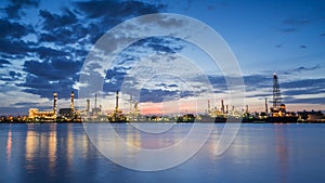 River side oil refinery industry plant along twilight morning