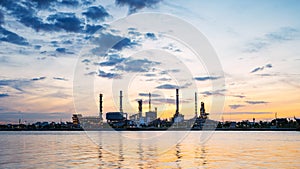 River side oil refinery industry plant along twilight morning