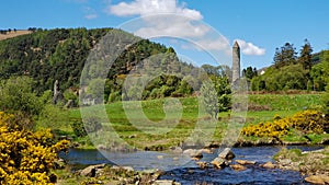 A river and stone tower view from Glendalough, Ireland