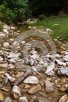 River stream water flow view. Water stnes in river stream.