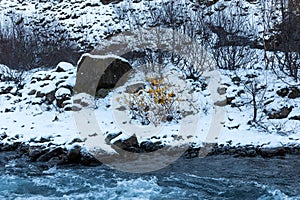 River streaming from the Glymur waterfall  in Iceland in winter