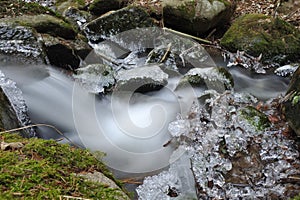 River strem with frozen icicles photo