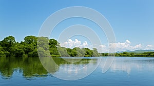 River summer landscape with bright blue sky and clouds