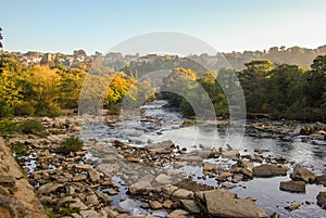 The River Swale with autumn foliage and houses
