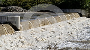 The river swollen after heavy rainfall and flood water crashing through valley. General contest of a river in flood