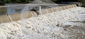 The river swollen after heavy rainfall and flood water crashing through valley. General contest of a river in flood