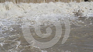 The river swollen after heavy rainfall and flood water crashing through valley. General contest of a river in flood