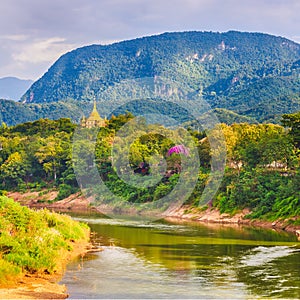 River, temple and mountains. Beautiful landscape. Laos.