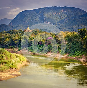 River, temple and mountains. Beautiful landscape. Laos.