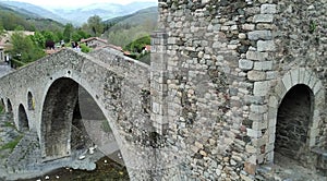 side view of the bridge and its entrance in Camprodon and the mountains on background. photo