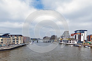 The River Thames flowing pass the city of Kingston upon Thames in Greater London, England