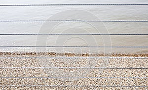 River Thames and Shingle beach behind wire rope fence