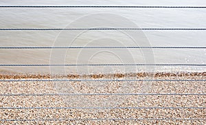 River Thames and Shingle beach behind wire rope fence