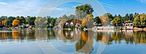River Tisza and tiny houses at its riverbank in autumn.