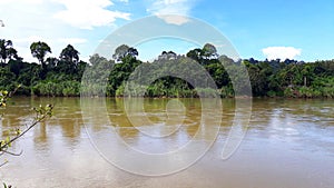 river and trees with clouds and clear sky.  River in Malinau Regency, North Kalimantan, Indonesia