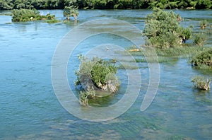 River Una on a summer day in Hrvatska Kostajnica, Croatia photo